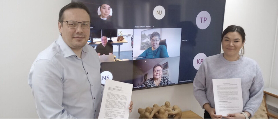 Naalakkersuisoq for finanser Erik Jensen (S) med borgmester i Kommuneqarfik Sermersooq Avaaraq Olsen (IA) samt flere af de øvrige borgmestre i baggrunden ved indgåelse af aftalen om næste års bloktilskud til kommunerne.